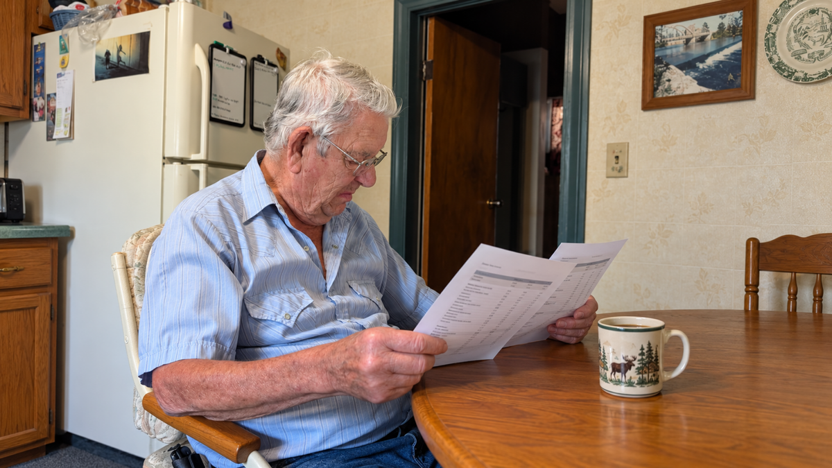 Man at kitchen table studying lab results
